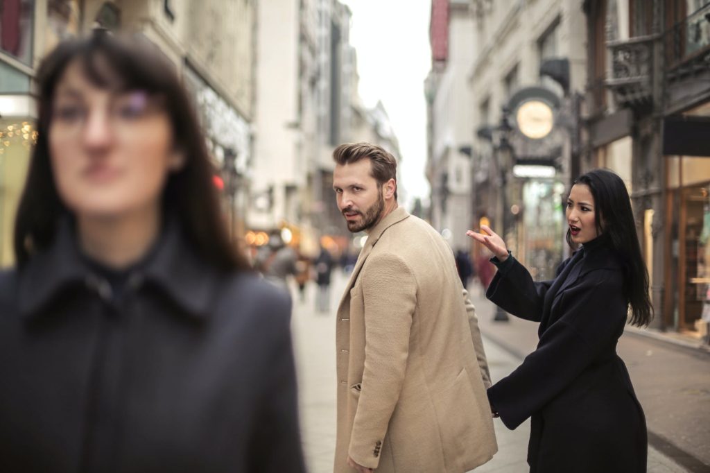 man in looking at another woman , signs a man is unhappy in his relationship