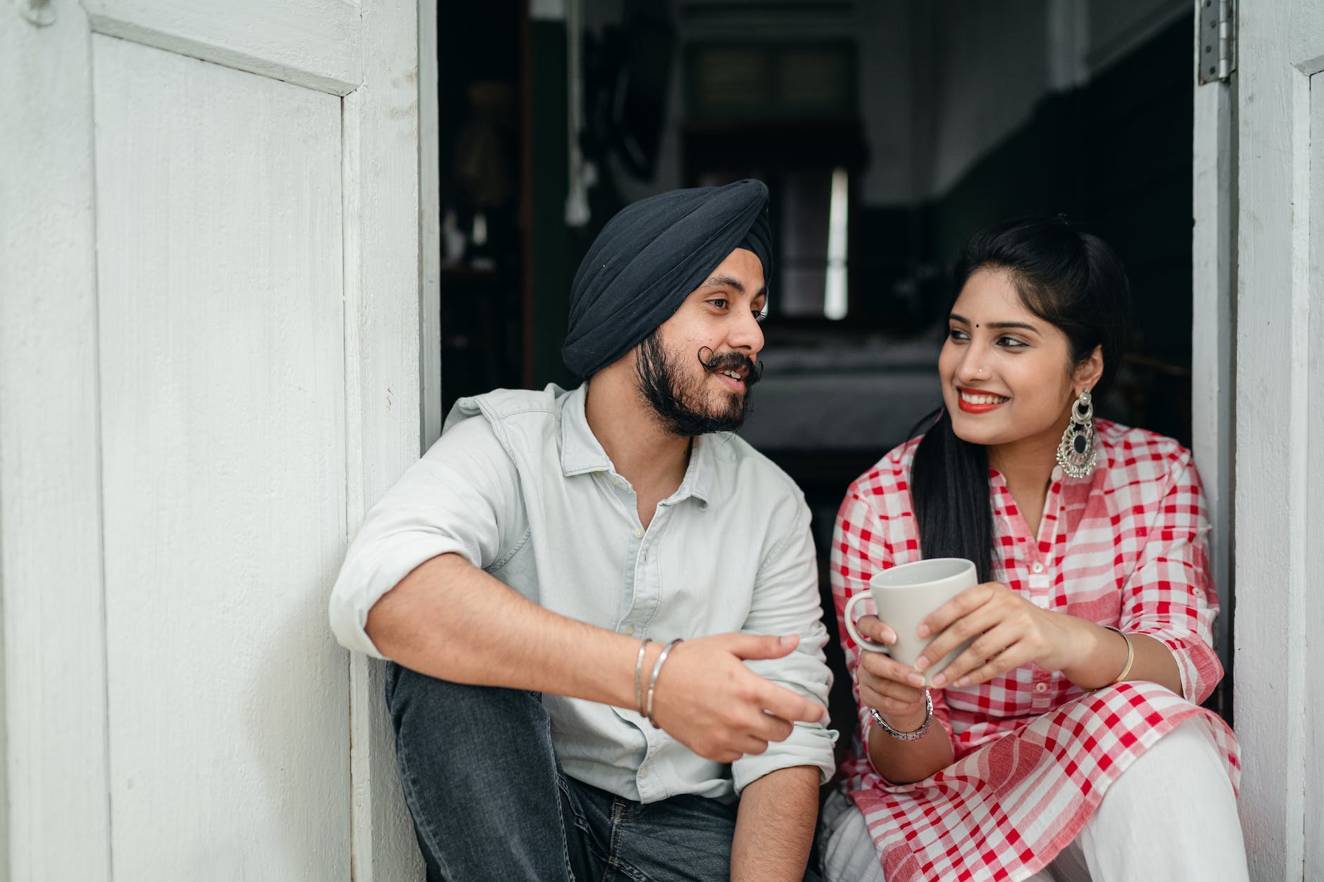 young couple in casual clothes enjoying coffee and chatting