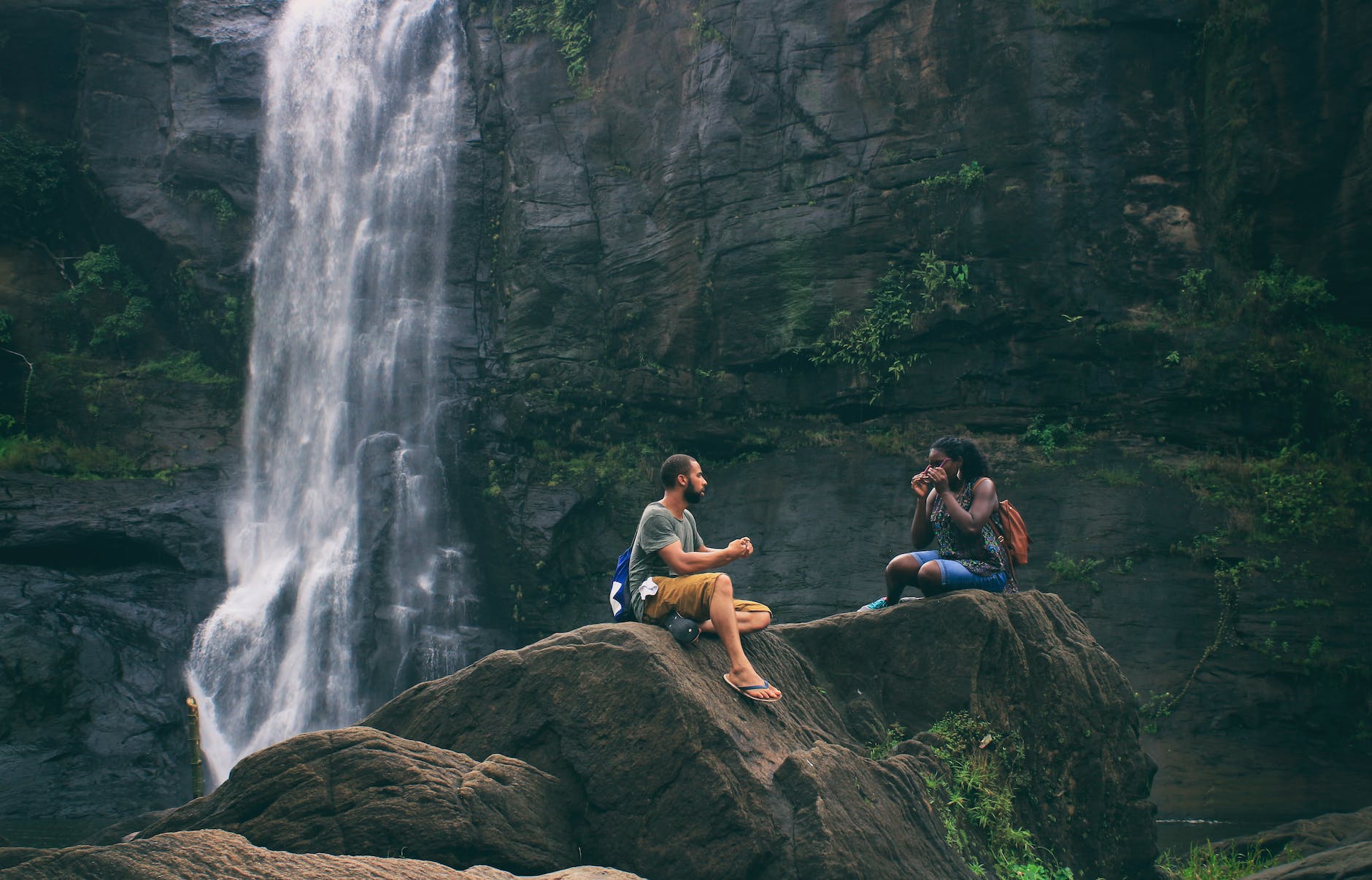 man and woman near waterfall nurturing their long-term relationship