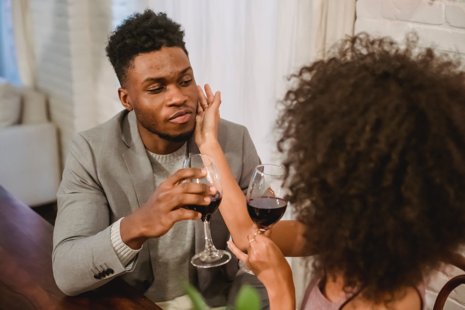 loving african american couple drinking wine