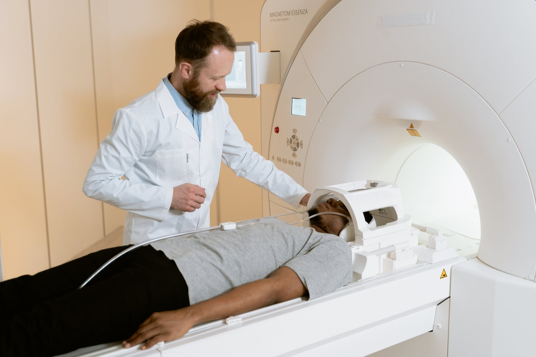 photo of doctor operating mri scanner for a brain tumor patient