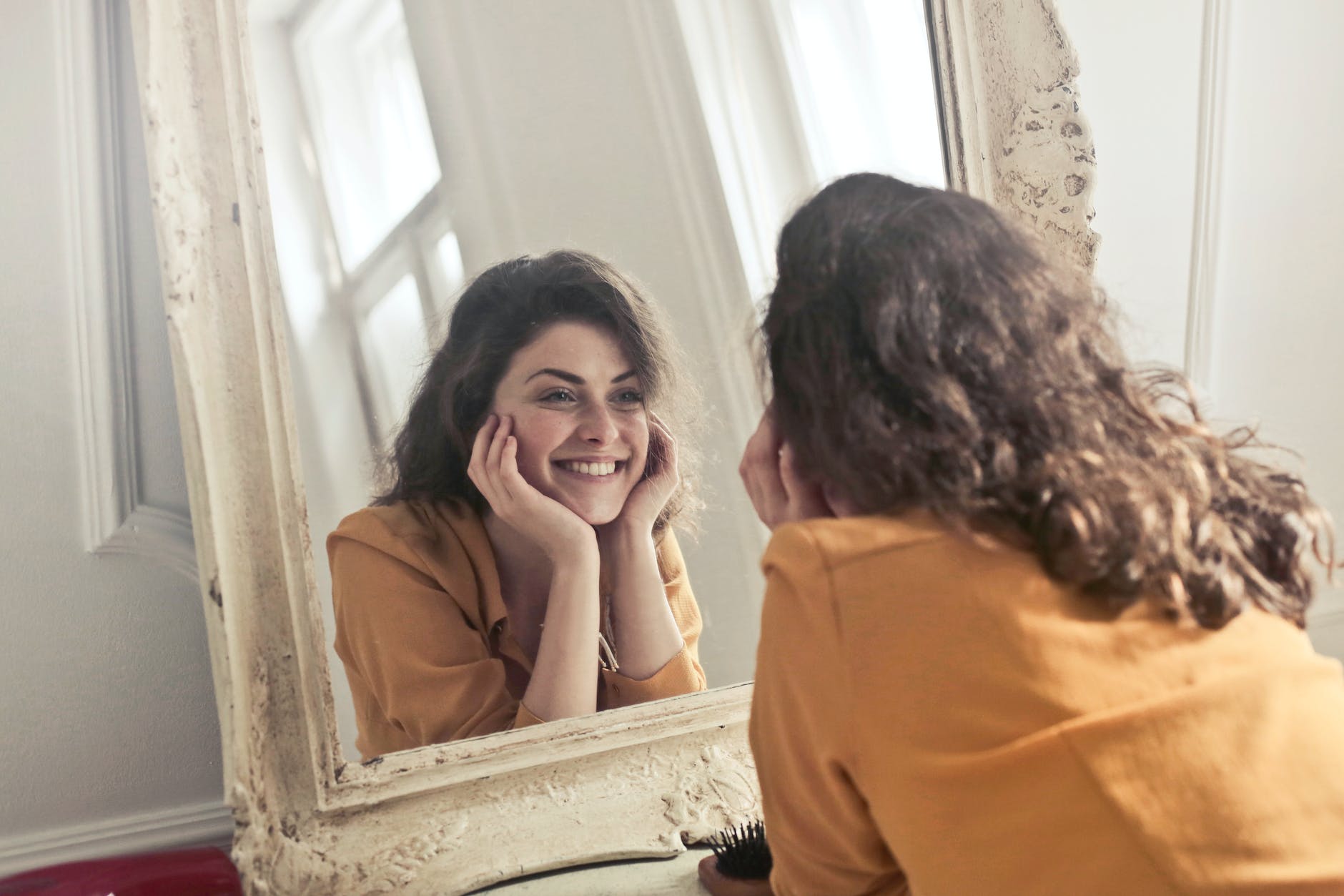 woman looking at the mirror thinking about Dating After A Breakup