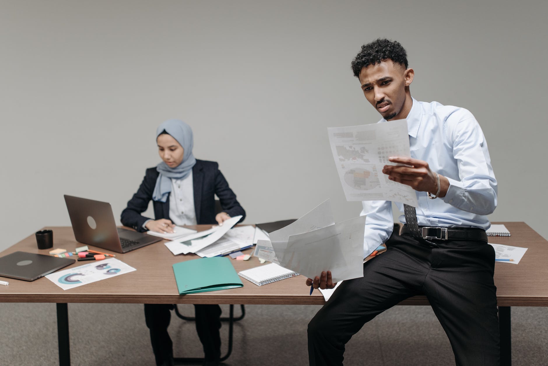 a man with angry face while looking a document