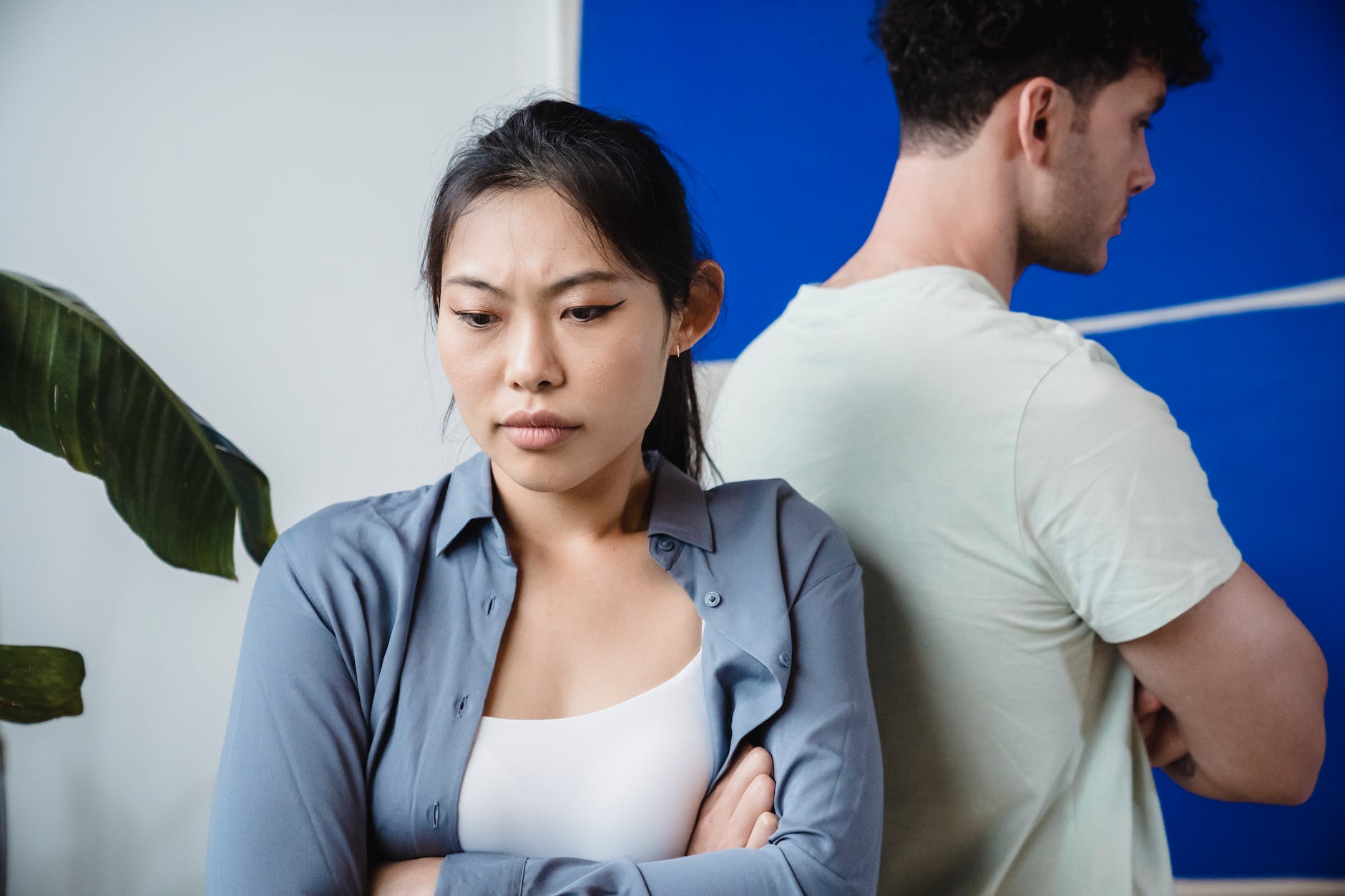 angry couple standing back to back