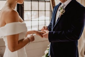 woman and man holding hands in marriage