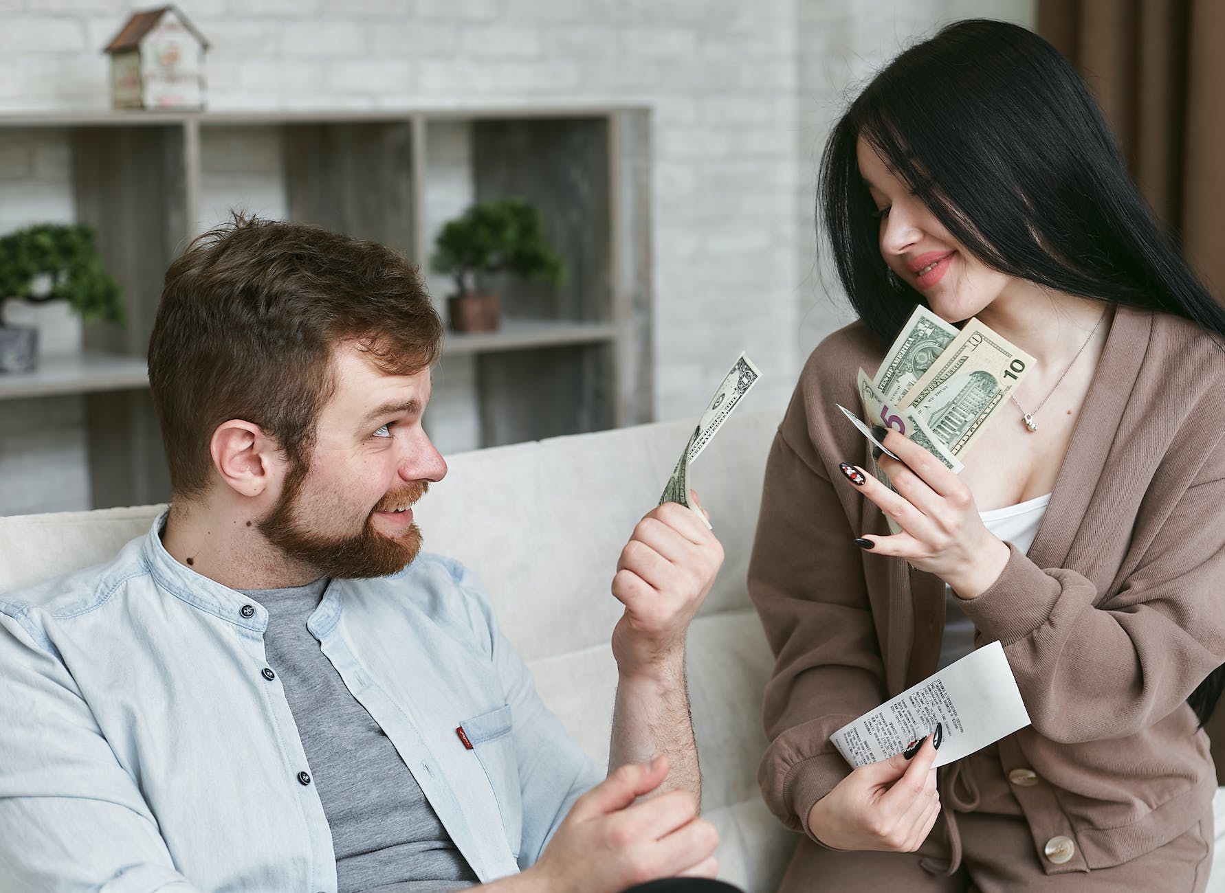 a man and woman holding a money