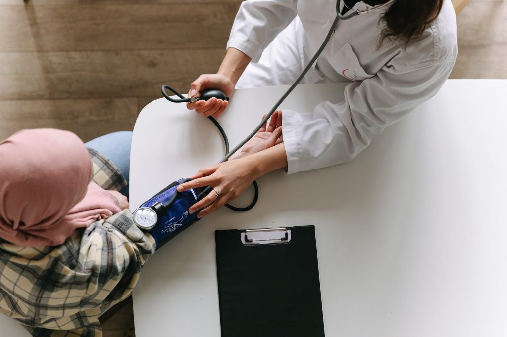 types of cancer: a doctor taking patient s blood pressure