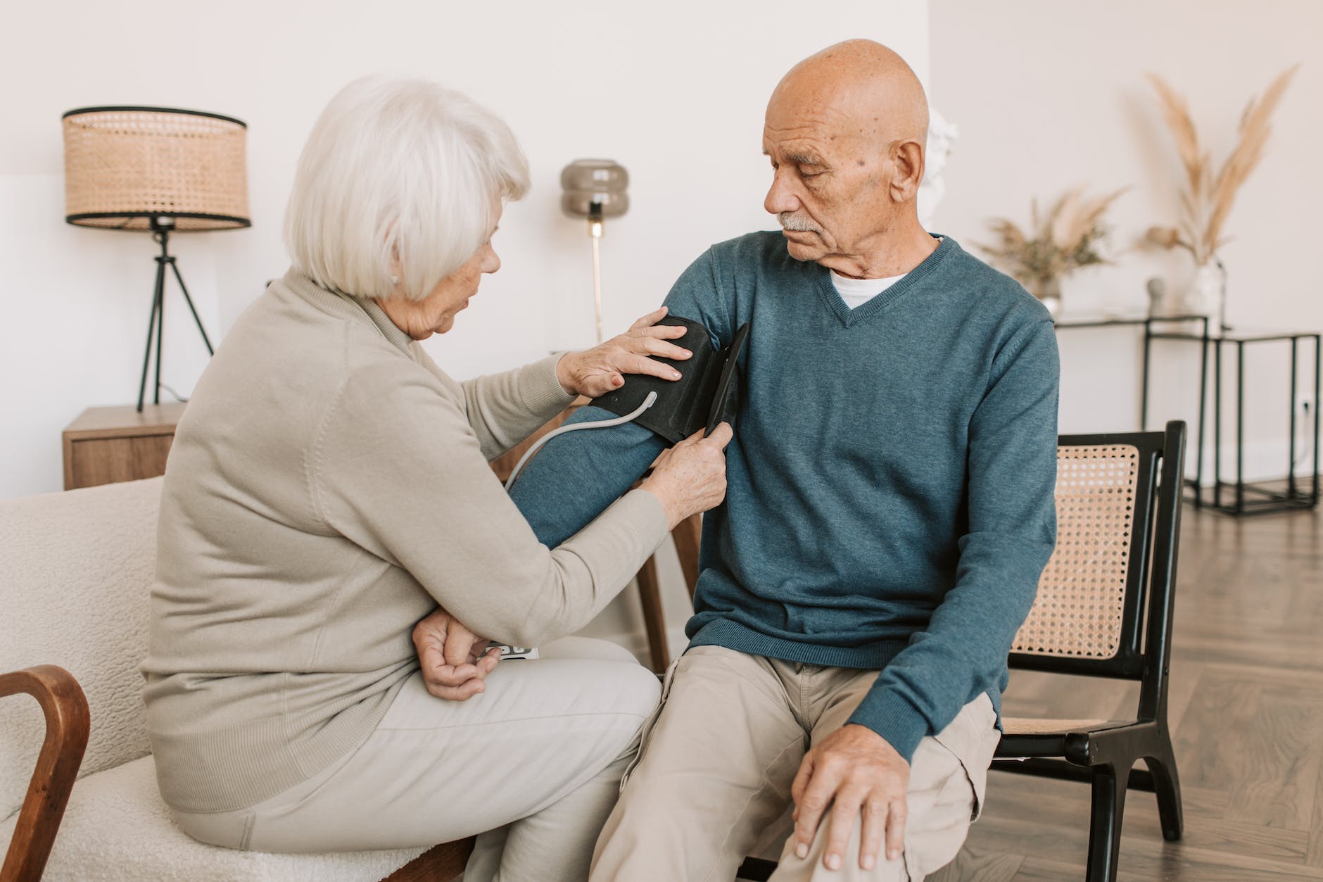 checking the blood pressure of an elderly man using a blood pressure measurement 