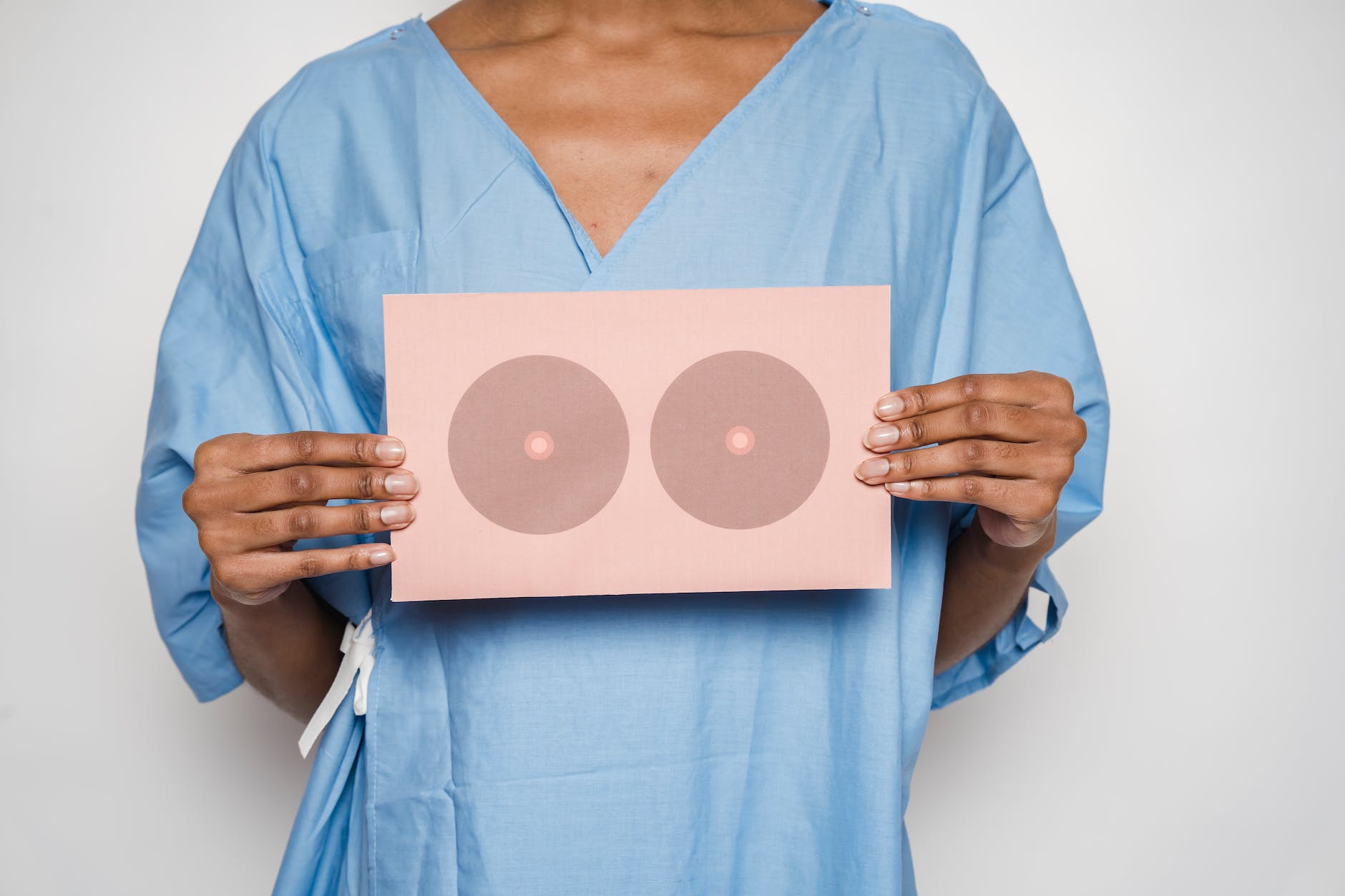 woman holding a card for breast cancer treatment