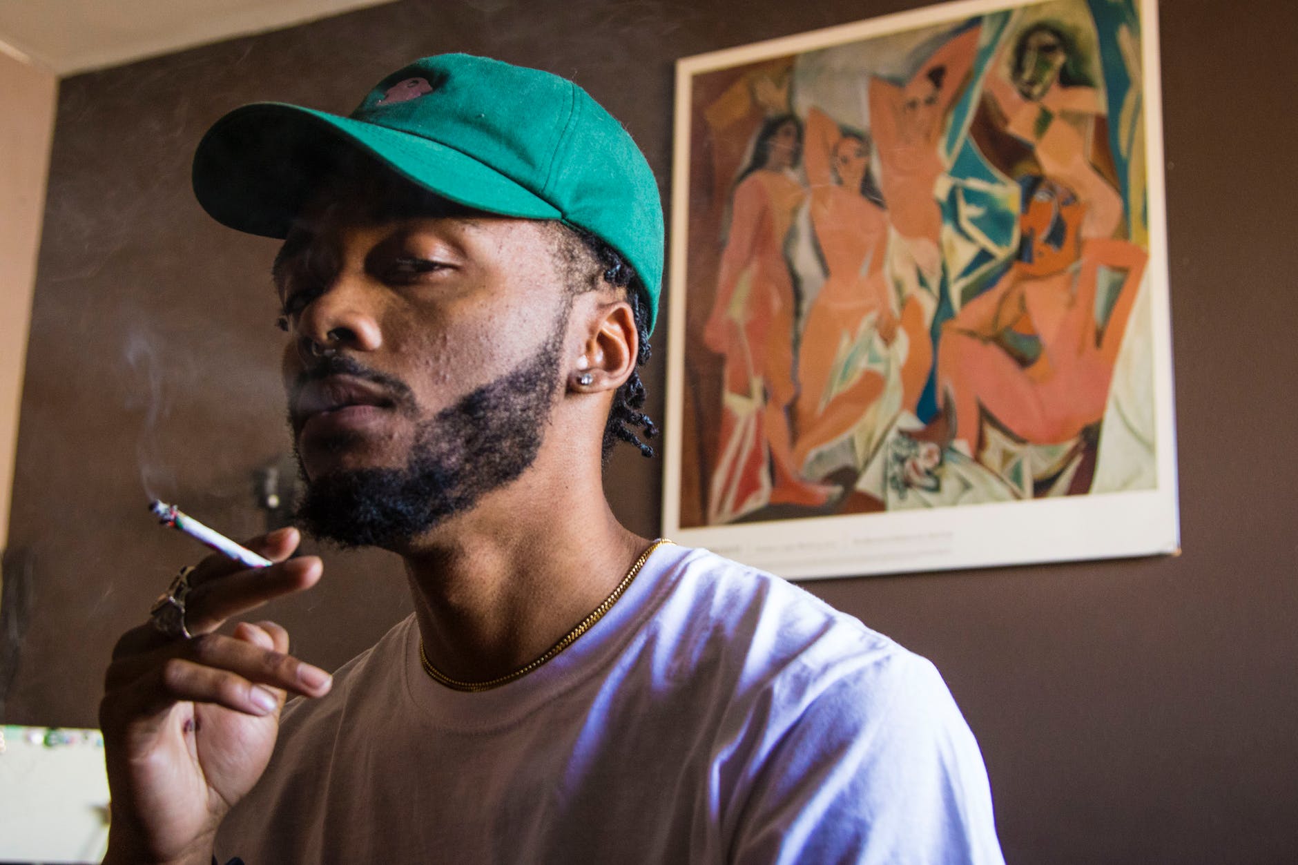 man stands near wall thinking about how to quit smoking