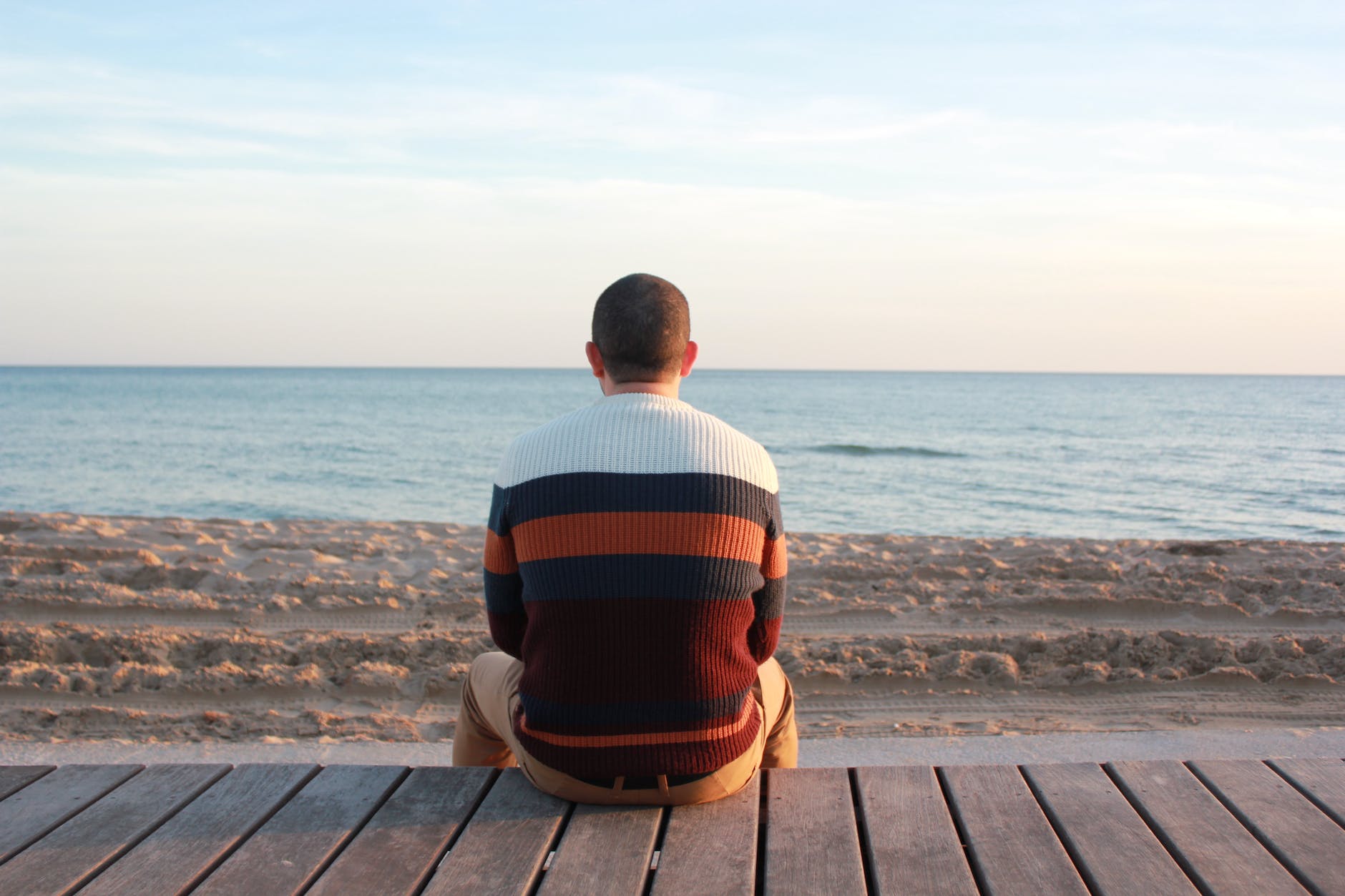 man sitting by the ocean: different personality types