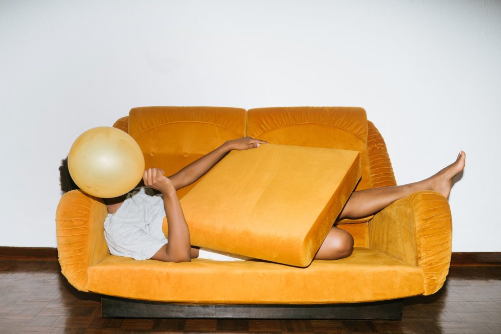 person lying on orange sofa after 16 Personalities Test