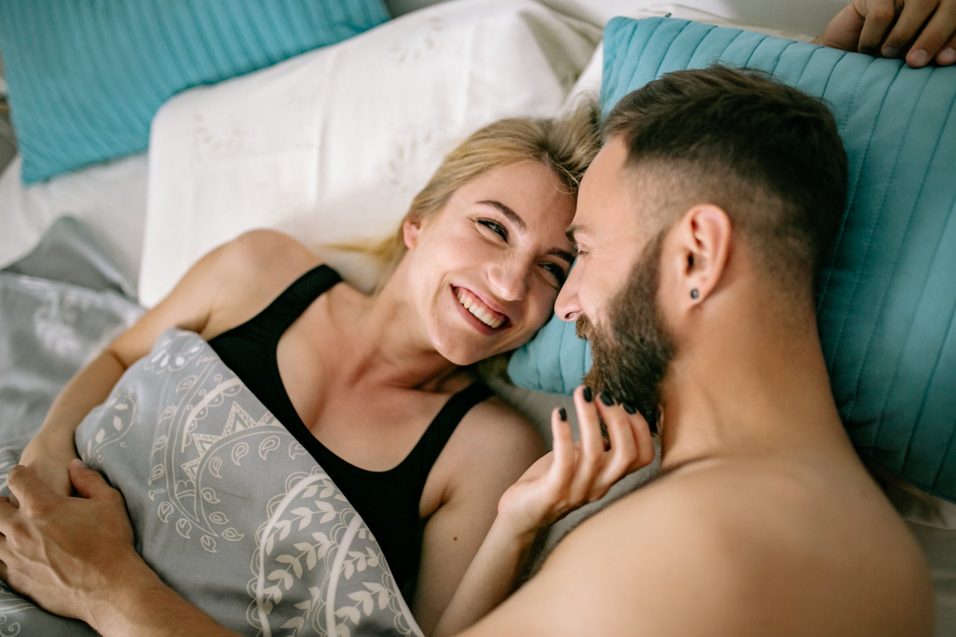 happy couple cuddling in bed