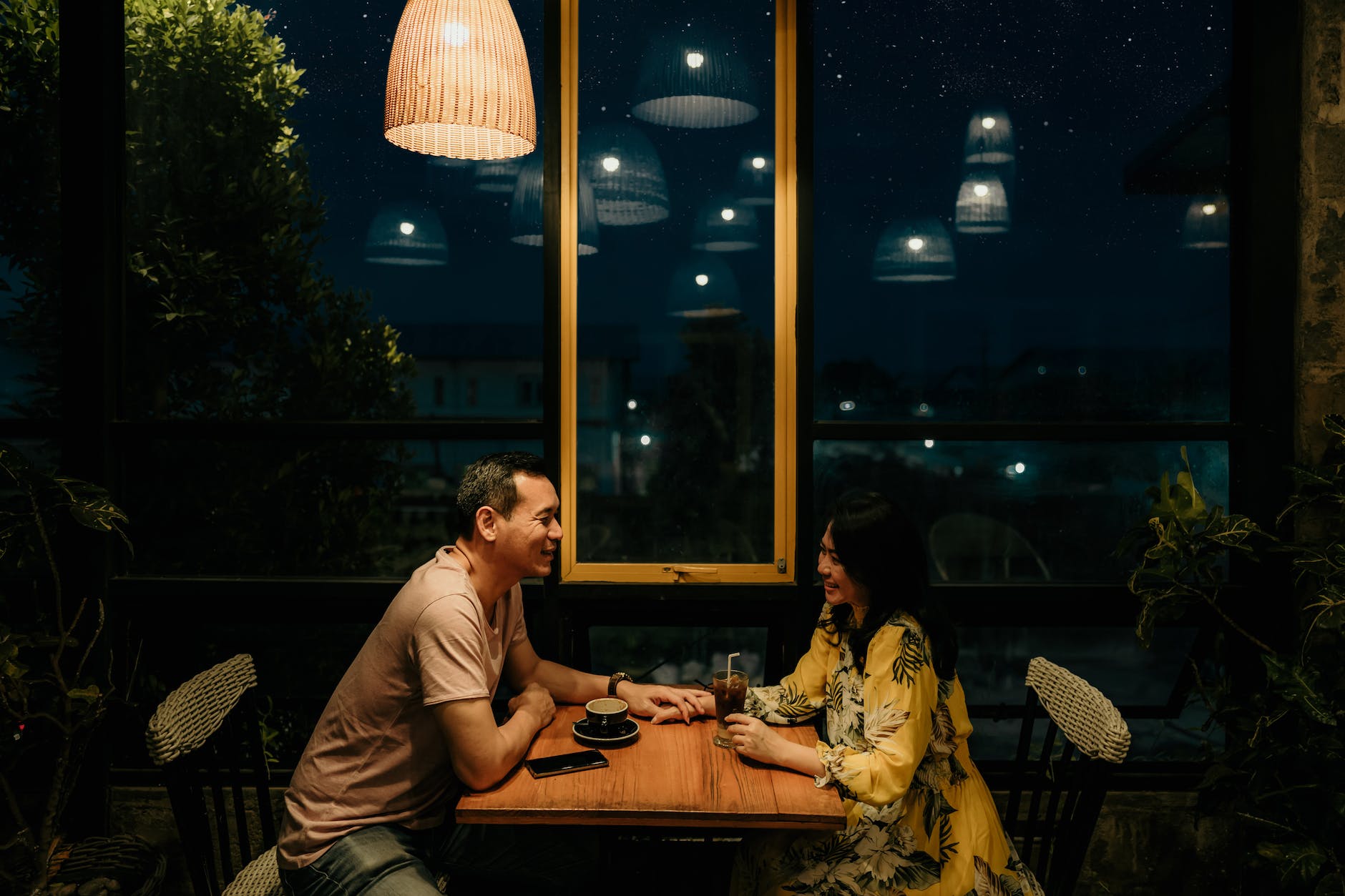 man and woman sitting on brown wooden table: Virtual Date Night