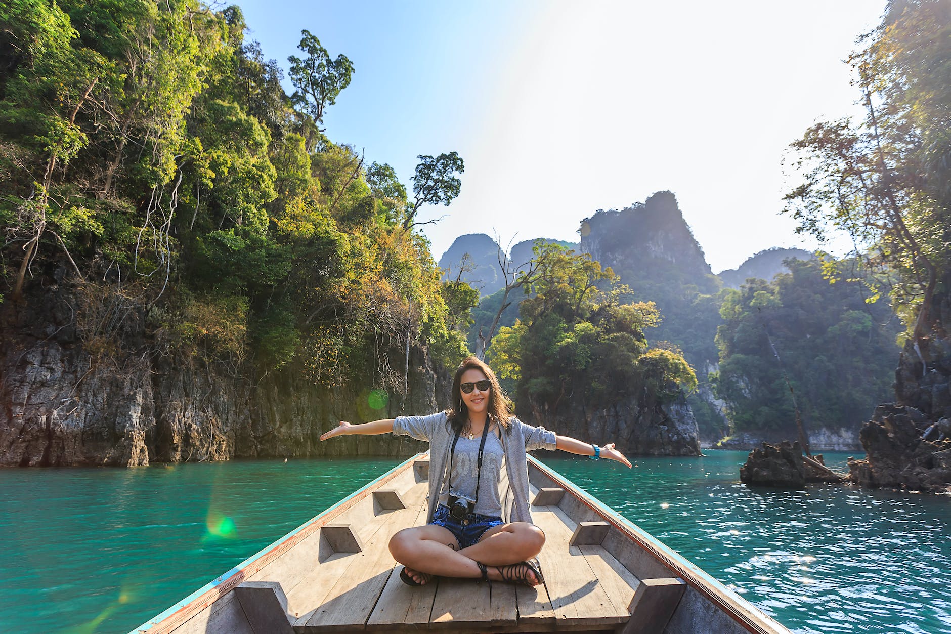 photo of woman sitting on boat spreading her arms Vacation